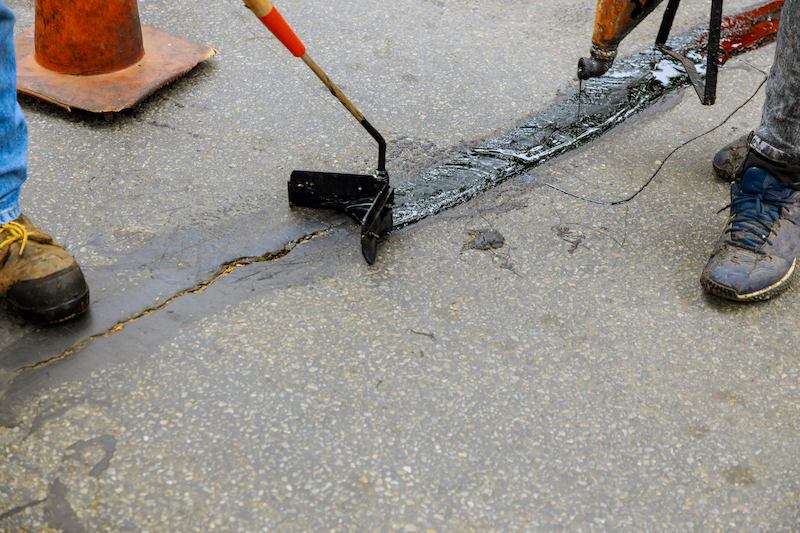 Crack filling and sealing work on asphalt pavement